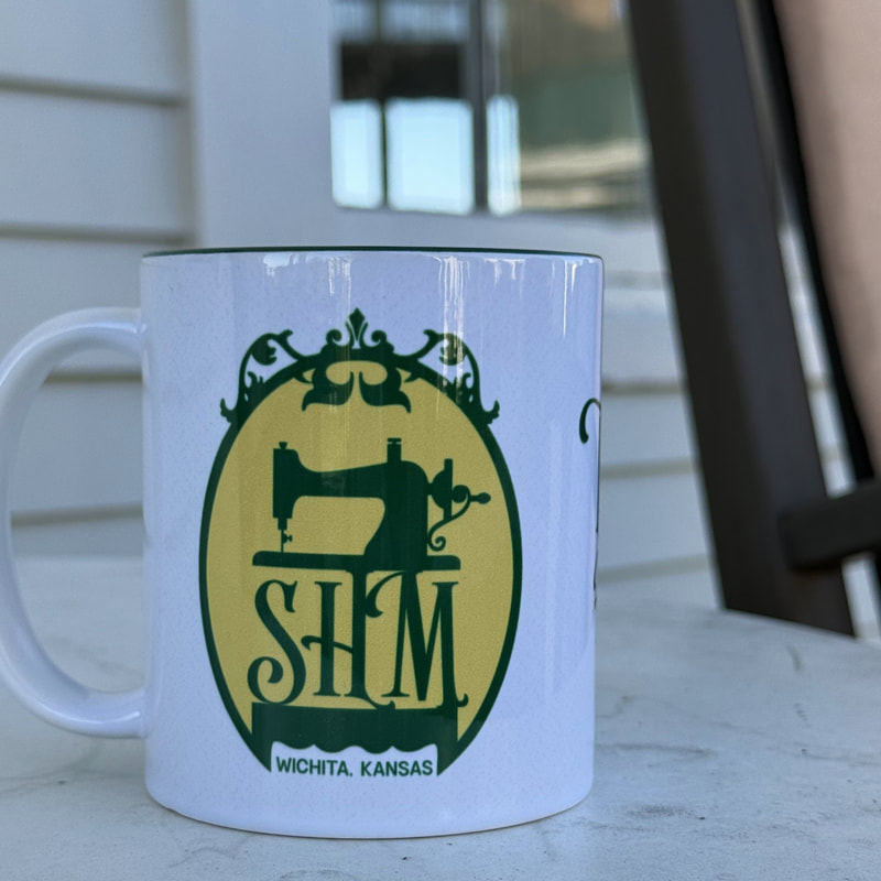 SHM-branded ceramic mug